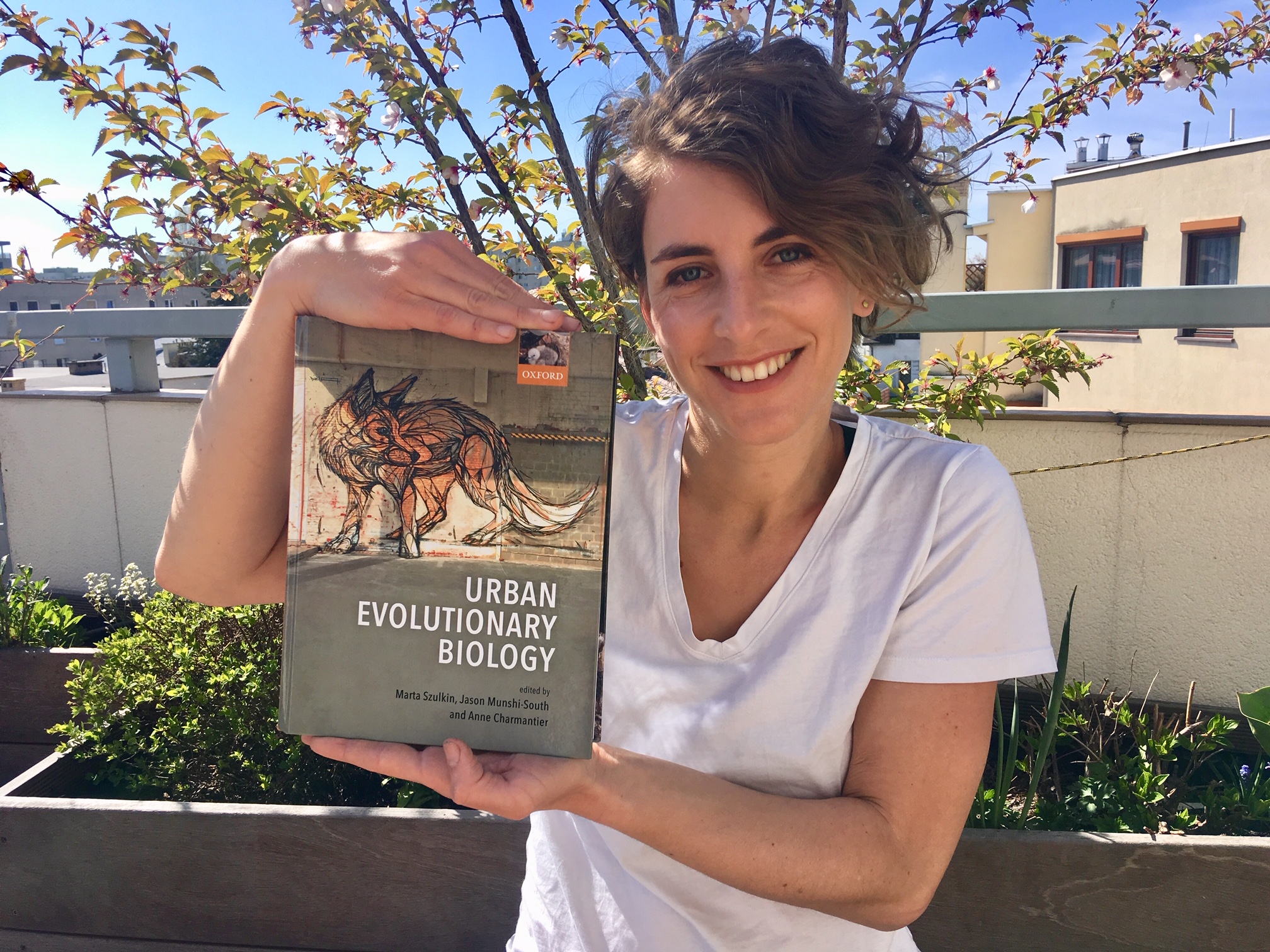 photo of Marta Szulkin, PhD and her book Urban Evolutionary Biology